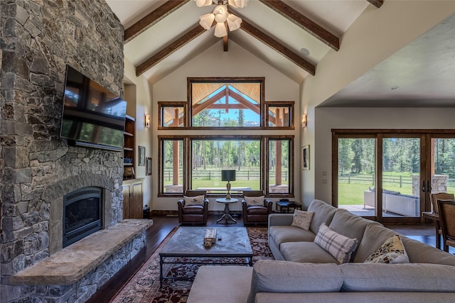 190 Black Bear Ln, Bigfork, MT 59911 - living area with high vaulted ceiling, wood-type flooring, plenty of natural light, a fireplace, and beam ceiling