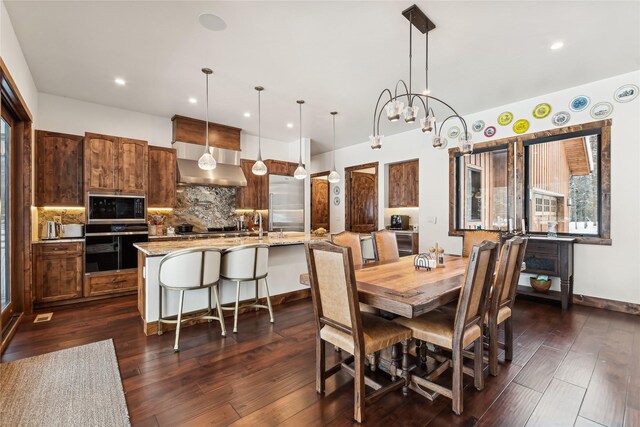 190 Black Bear Ln, Bigfork, MT 59911 - dining area featuring dark wood-type flooring, recessed lighting, a chandelier, and baseboards