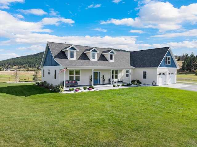 view of front of house with a porch, a garage, and a front yard