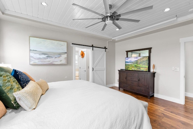 bedroom featuring dark hardwood / wood-style floors, ceiling fan, a barn door, wood ceiling, and ornamental molding