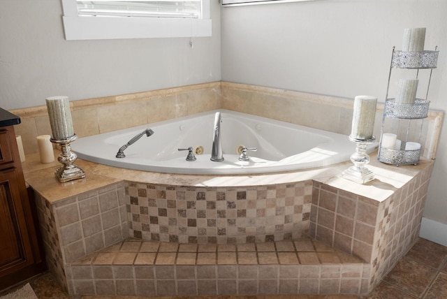 bathroom featuring vanity, tile patterned flooring, and a relaxing tiled tub