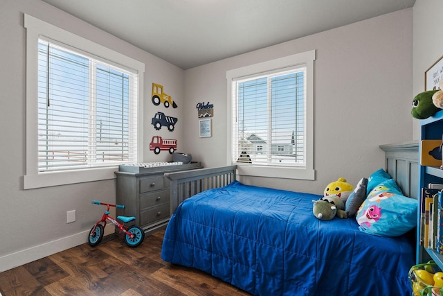 bedroom with dark hardwood / wood-style flooring