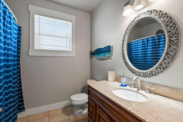 bathroom featuring vanity, tile patterned flooring, and toilet