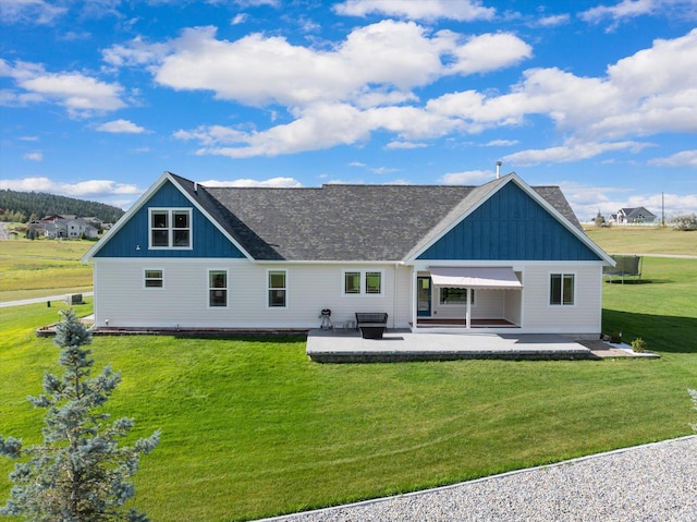 rear view of house with a lawn and a patio area