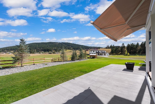 view of patio with a mountain view and a rural view