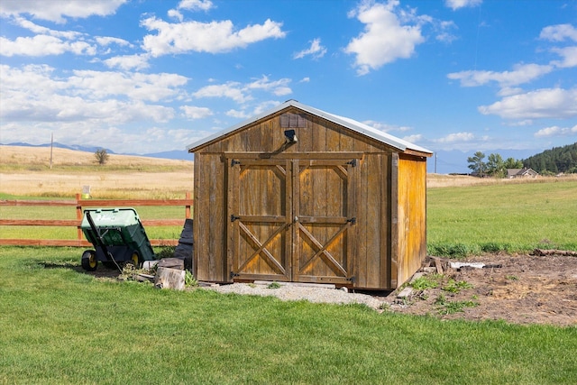 view of outdoor structure featuring a yard and a rural view