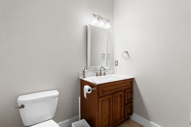 bathroom with toilet and vanity