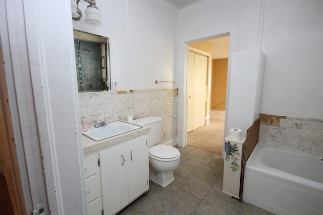 full bathroom with tile patterned flooring, toilet, vanity, a garden tub, and tile walls