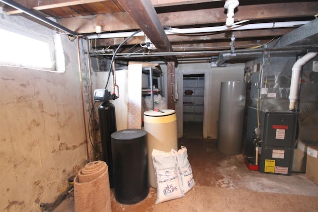 basement featuring heating unit and water heater