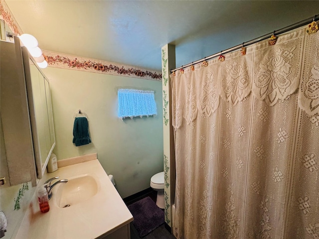 bathroom featuring toilet and vanity