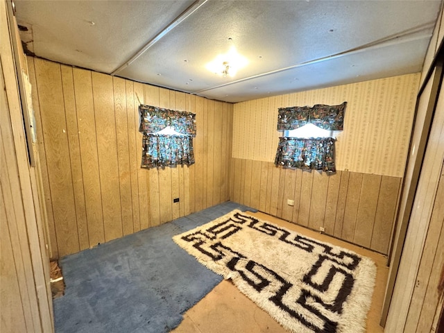 spare room with wood walls