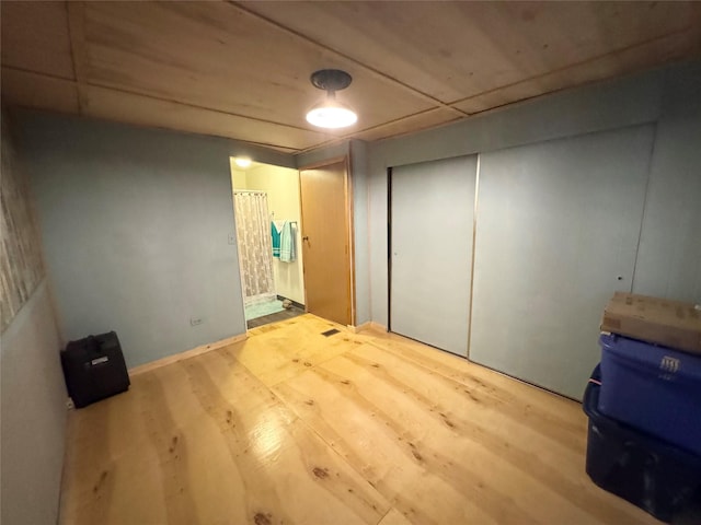 unfurnished bedroom featuring a closet and light wood-type flooring