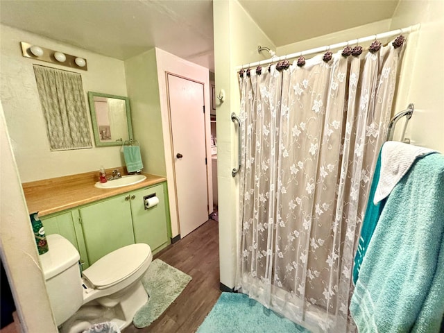 bathroom with toilet, vanity, walk in shower, and hardwood / wood-style floors