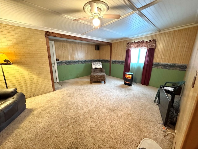 living area with brick wall, carpet floors, and ceiling fan