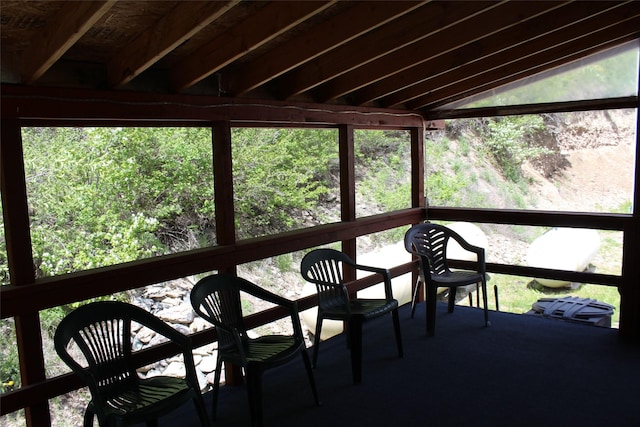 sunroom featuring lofted ceiling