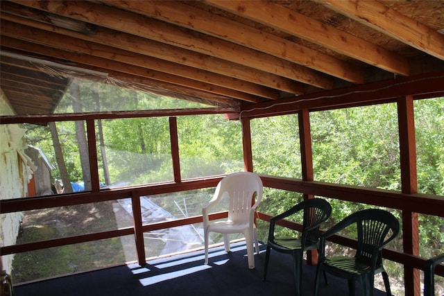 sunroom / solarium featuring vaulted ceiling