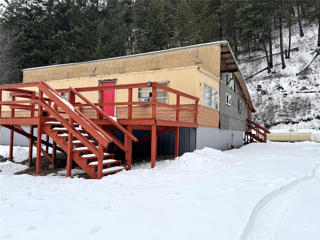 view of snow covered back of property