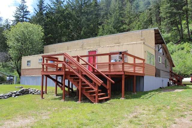 back of house with a yard and a deck