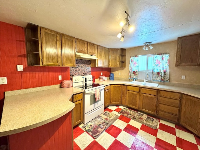 kitchen with rail lighting, kitchen peninsula, white range with electric stovetop, a textured ceiling, and sink