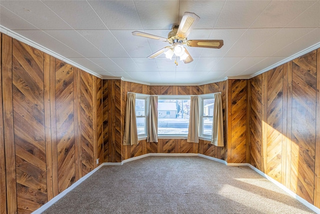 spare room featuring carpet floors, crown molding, and ceiling fan