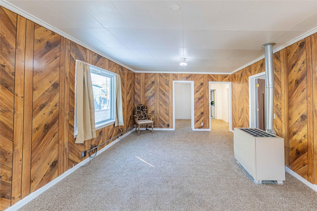 carpeted spare room featuring crown molding