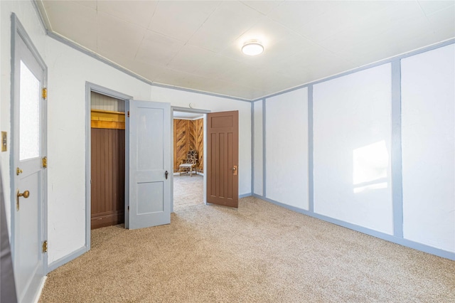 unfurnished bedroom featuring a closet and light colored carpet