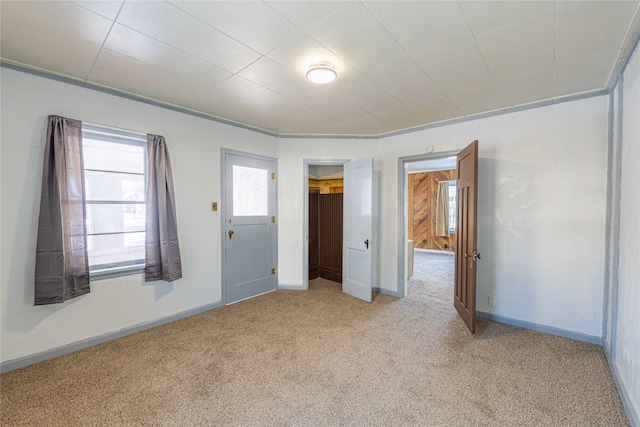 unfurnished bedroom featuring light carpet, a closet, and ornamental molding