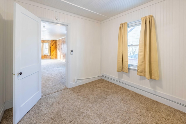 carpeted spare room featuring wooden walls