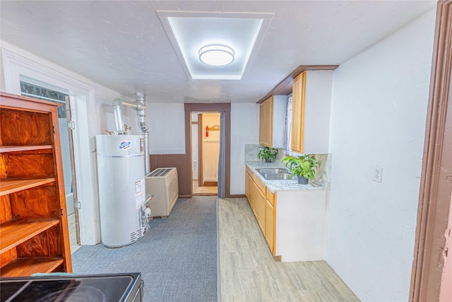 interior space with water heater, washer and clothes dryer, and sink