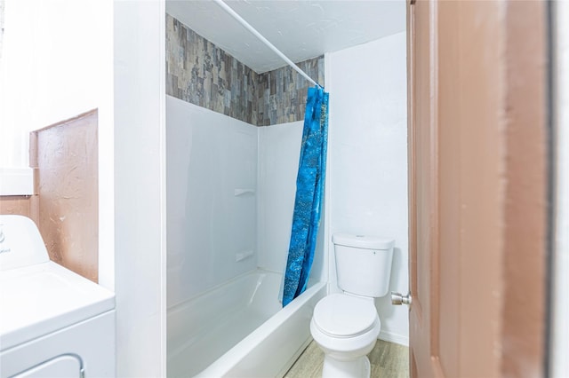 bathroom featuring toilet, shower / tub combo, and washer / dryer