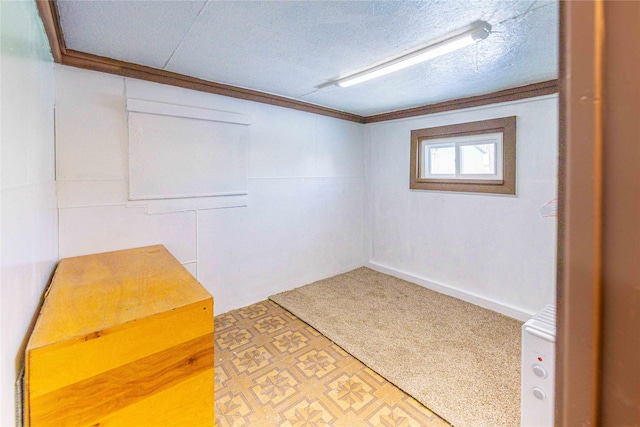 interior space featuring a textured ceiling and crown molding