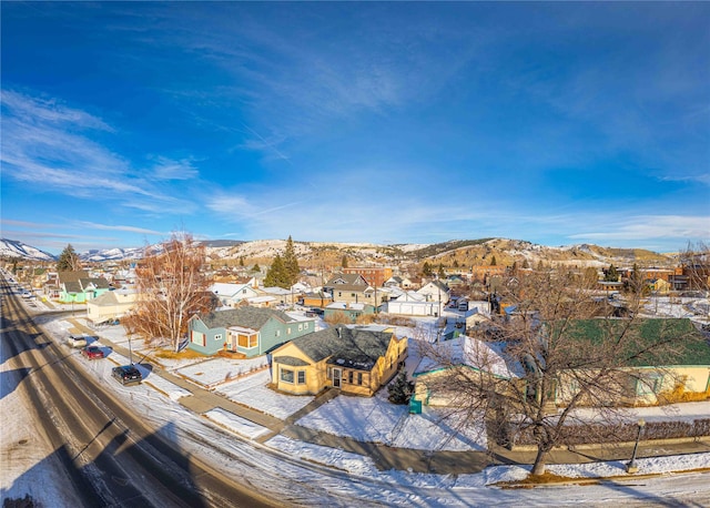 snowy aerial view with a mountain view