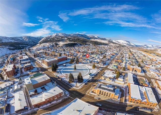 snowy aerial view featuring a mountain view