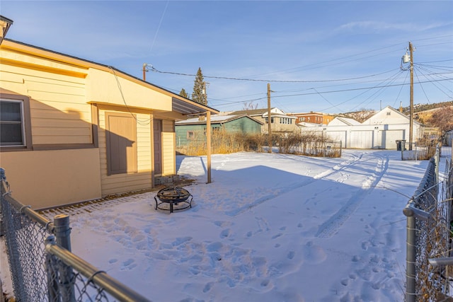 snowy yard with a fire pit