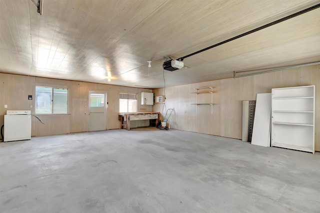 garage featuring a garage door opener and washer / clothes dryer