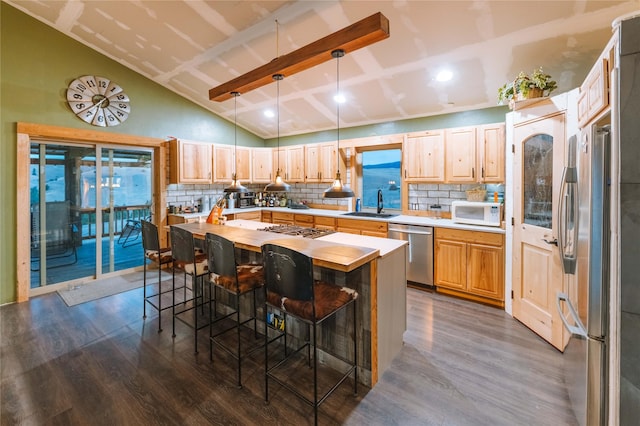 kitchen with dark wood-type flooring, backsplash, and appliances with stainless steel finishes