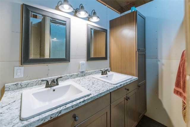 bathroom featuring a sink and double vanity