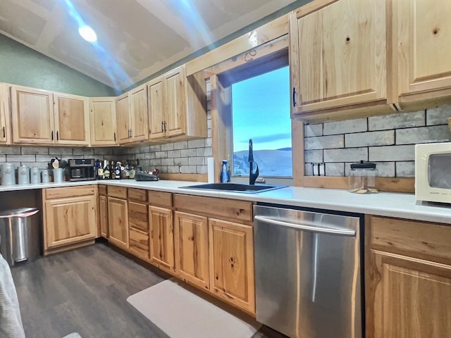 kitchen featuring dishwasher, lofted ceiling, white microwave, light countertops, and a sink