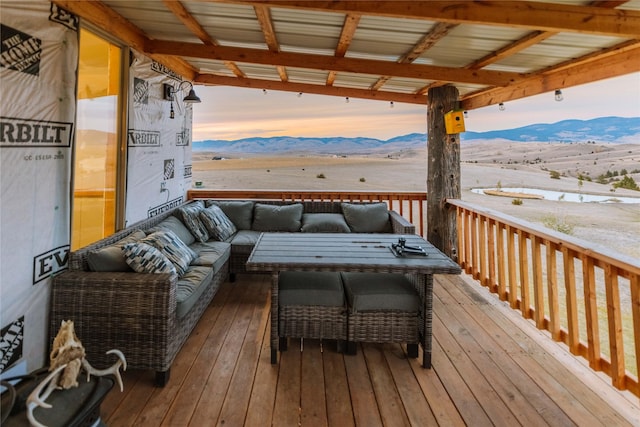 wooden terrace with a mountain view and an outdoor hangout area