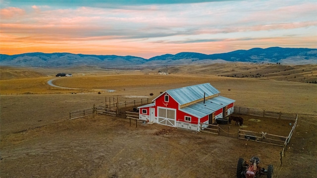 aerial view at dusk with a rural view and a mountain view