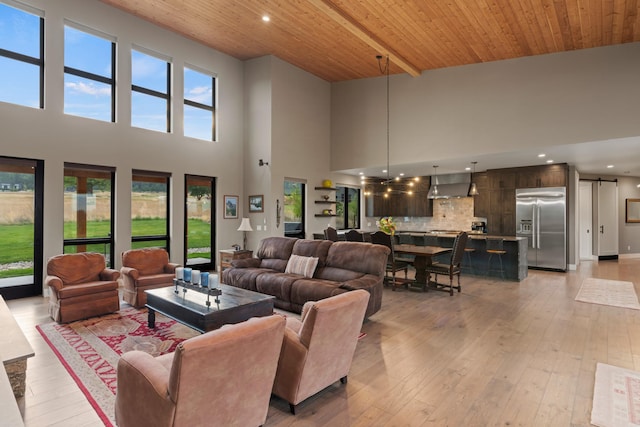 living room featuring wooden ceiling, light hardwood / wood-style floors, beam ceiling, and a high ceiling