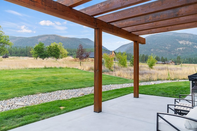 view of patio / terrace featuring a pergola and a mountain view