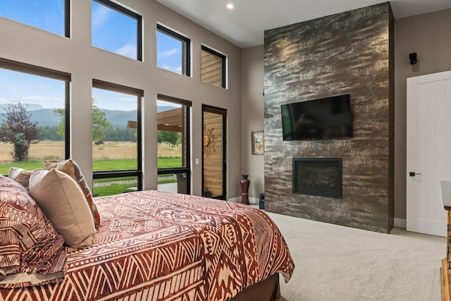 bedroom featuring a fireplace and carpet flooring