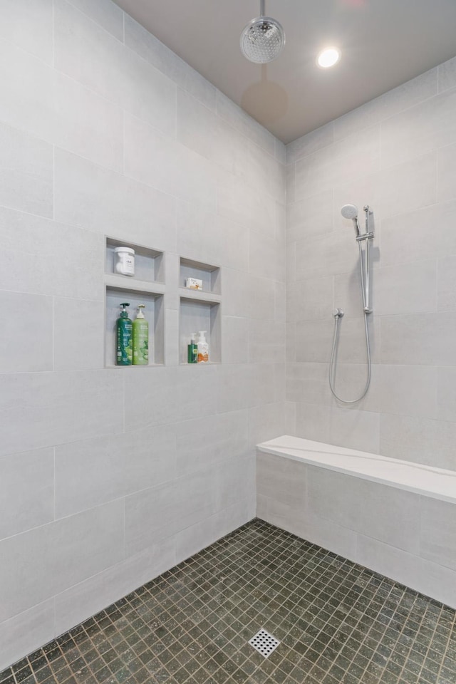 bathroom with a tile shower