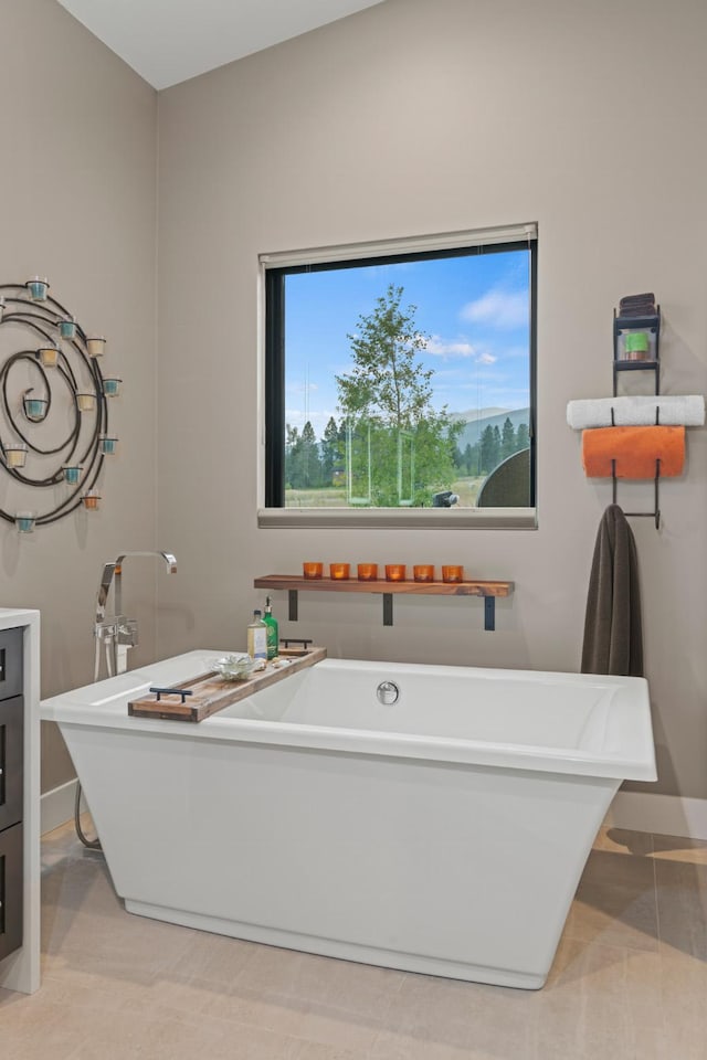 bathroom featuring a tub to relax in and vanity