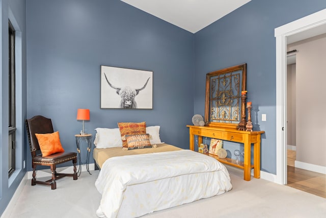 bedroom featuring light colored carpet