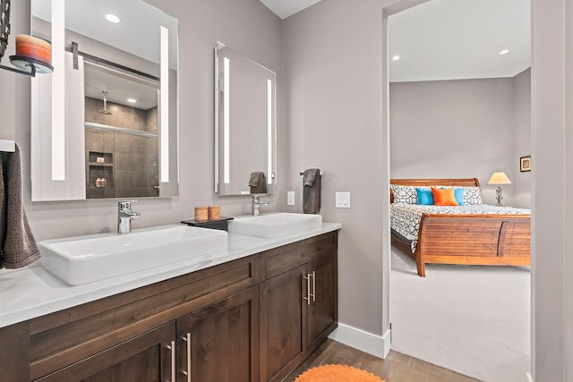 bathroom featuring a shower with door, wood-type flooring, and vanity