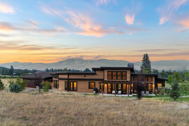 back house at dusk featuring a mountain view