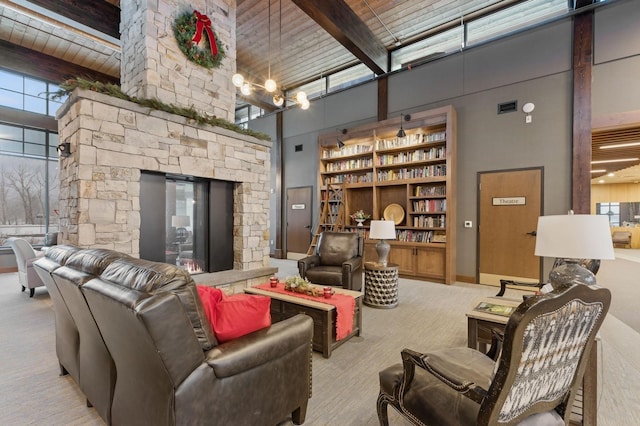 carpeted living room with beamed ceiling, wooden ceiling, and a high ceiling