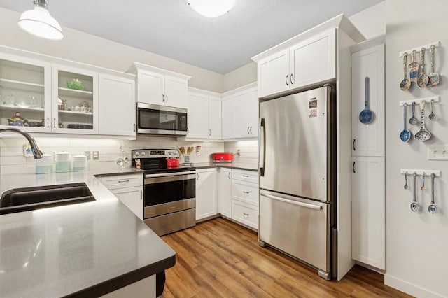 kitchen featuring stainless steel appliances, sink, and white cabinets